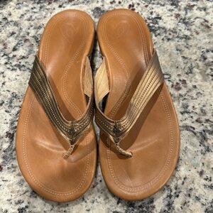 OluKai Women's Brown Leather Flip Flop Sandals with Metallic Bronze Straps